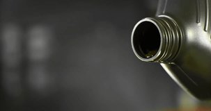 Super slow motion (1000 fps) close-up of motor oil pouring from a container. Smooth golden liquid flow with bubbles and reflections, isolated cinematic shot with shallow depth of field. - Powered by Shutterstock - Get 15% off with code: PIKWIZARD15