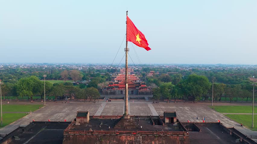 Vietnam flag flying about Imperial City of Hue - Aerial drone reveal of historic citadel

Keywords language: English