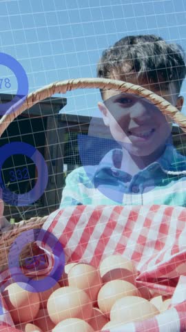 Male child shifting grip, rotating basket to camera, presenting eggs with moving blue grid for food. Kid, backyard, sunny, portrait, woven, container, vertical video