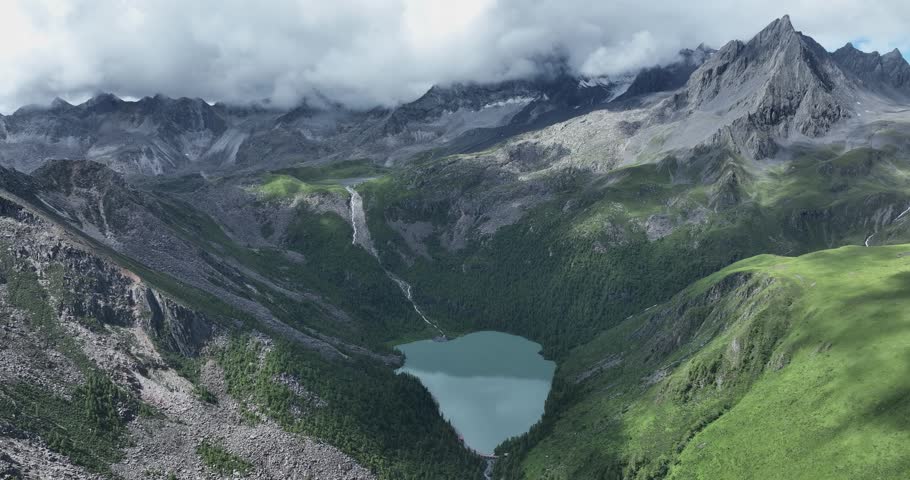 Aerial view of beautiful high altitude lake and snow capped mountain landscape