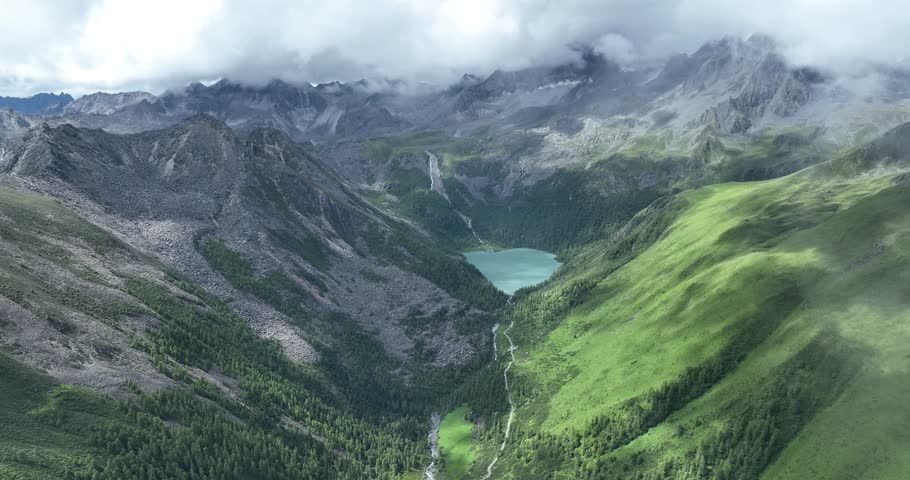 Aerial view of beautiful high altitude lake and snow capped mountain landscape