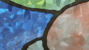 A high-quality, abstract close-up shot of a decorative stained glass window. The footage showcases intricate geometric patterns and a rich palette of colors including green, blue, purple, and amber. The textured glass surfaces capture and refract light beautifully, creating a vibrant and artistic mosaic effect. Ideal for creative backgrounds, spiritual themes, architectural showcases, or artistic transitions. - Powered by Shutterstock - Get 15% off with code: PIKWIZARD15