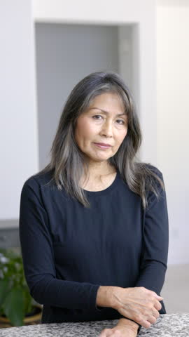 Smiling attractive woman looking at camera standing motions to come to her with hand vertical video copy space