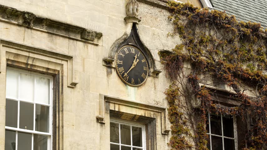 Close up of decorative clock on Lincoln College limestone building in Oxford