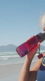 Animation of social media data processing over caucasian drinking during exercis on beach. Global fitness, networks, computing, digital interface and data processing concept digitally generated video. - Powered by Shutterstock - Get 15% off with code: PIKWIZARD15