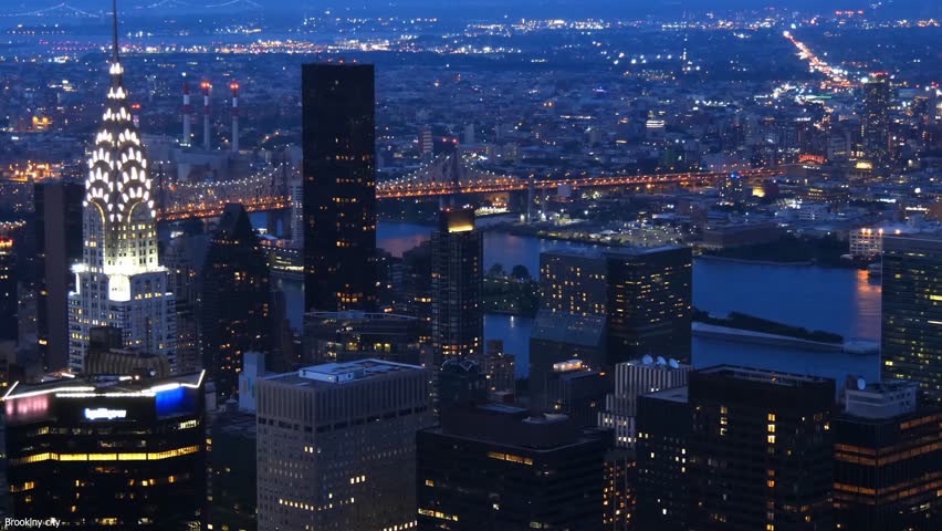 Night city skyline with illuminated buildings and urban lights.