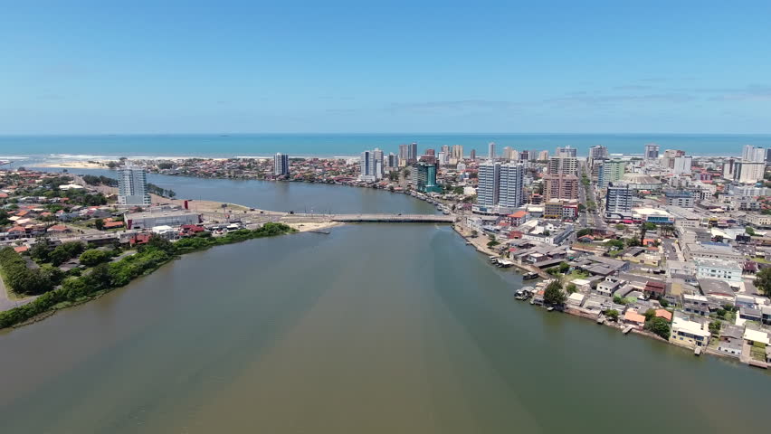 Aerial approach descending toward the bridge linking Imbe and Tramandai over the Tramandai River in southern Brazil.