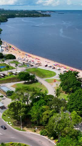 Nature Ponte Negra urban beach at downtown Manaus Brazil. Landmark beach recreation at Black River near Amazon River and Amazon Forest. Tropical travel destination. Outdoor scenery. Manaus Brazil.