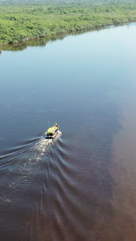 Panning wide view of vibrant river at coast city of Itanhaem Sao Paulo Brazil. South coast of state of Sao Paulo. Tropical scenery. Travel destinations. Vacation travel. Popular tourism landmark.