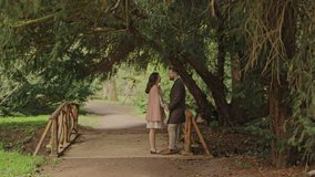 Romantic couple holding hands on wooden bridge forest park - Powered by Shutterstock - Get 15% off with code: PIKWIZARD15