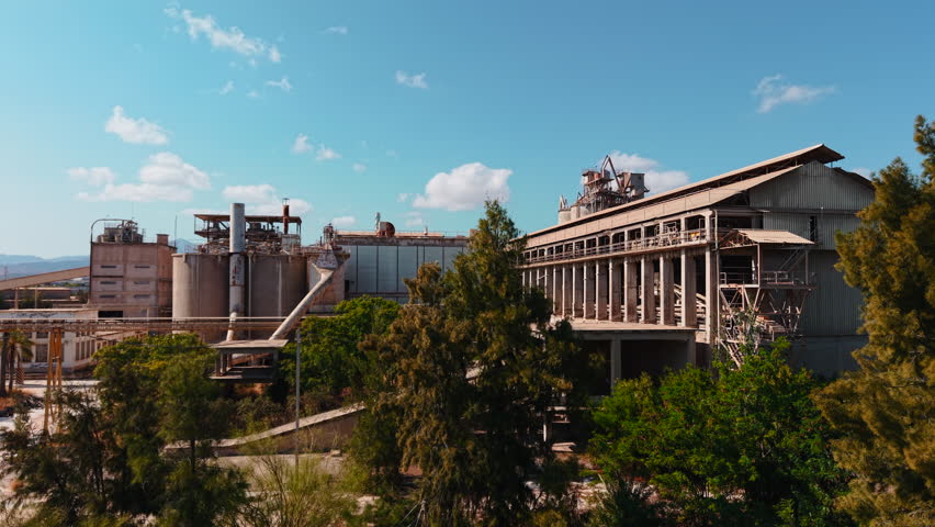 Aerial view of an abandoned industrial factory complex on a sunny day