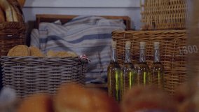 Camera moving forward, bread loaves coming into focus as green,yellow charts tracking bakery sales. Rolls, braided, sesame, powdered, baskets, napkin, oil - Powered by Shutterstock - Get 15% off with code: PIKWIZARD15