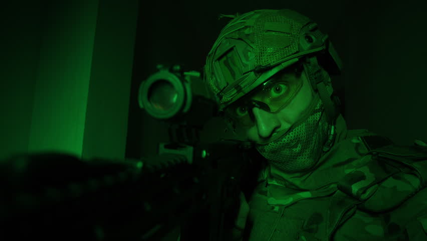 Portrait of modern soldier in military uniform and a helmet with headphones rifle, army warrior Warrior Military Gear Ready for Battle, airsoft Players in Tactical Gear and Riot Police Training