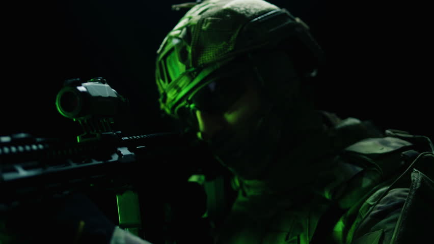 Portrait of modern soldier in military uniform and a helmet with headphones rifle, army warrior Warrior Military Gear Ready for Battle, airsoft Players in Tactical Gear and Riot Police Training