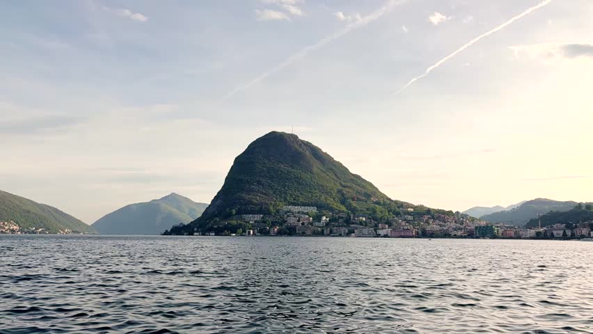 Lake Lugano View Through Lush Park Vegetation with Monte San Salvatore Mountain, Scenic Nature Landscape for Travel and Relaxing Background