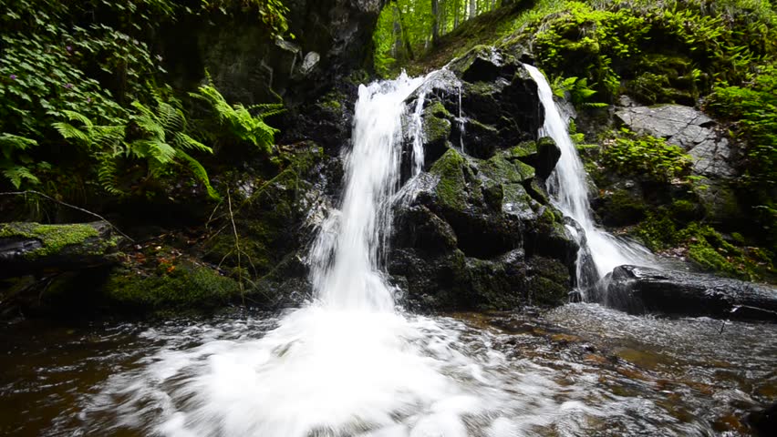 Waterfall Bottom, rock splits the water on two waterfall Cascades. HD loop