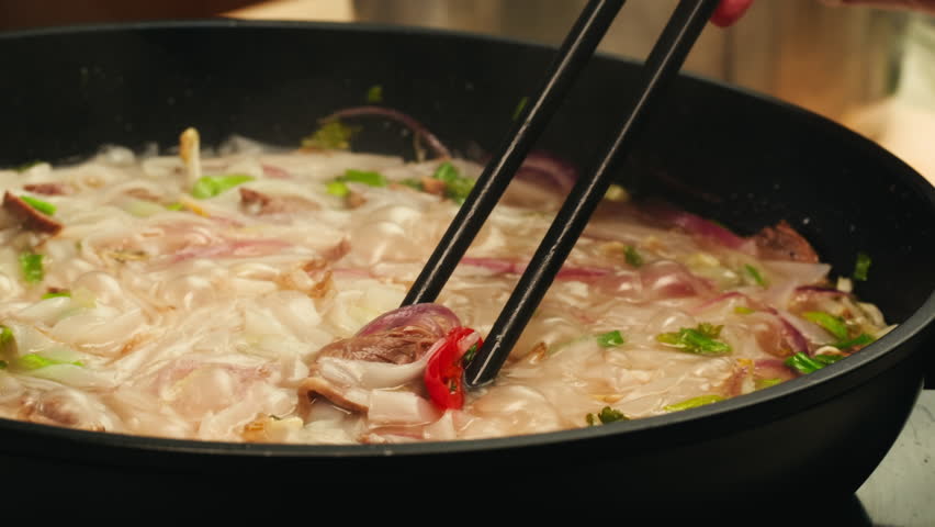 Vietnam traditional pho bo soup on delivery, Beef noodles. Pho Bo Soup with beef, rice noodles, ginger, lime, chili pepper in bowl. Vietnamese cuisine. Pho Noodle Soup restaurant Close-up.