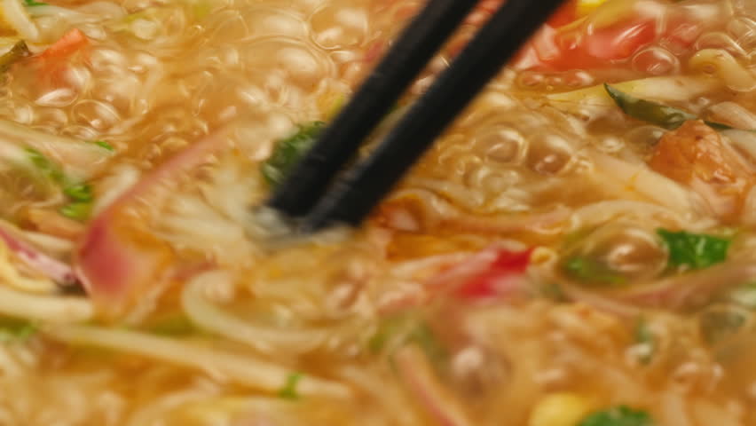 Vietnam traditional pho bo soup on delivery, Beef noodles. Pho Bo Soup with beef, rice noodles, ginger, lime, chili pepper in bowl. Vietnamese cuisine. Pho Noodle Soup restaurant Close-up.