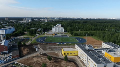 Drone Flying Forward over Stadium Forest Area
