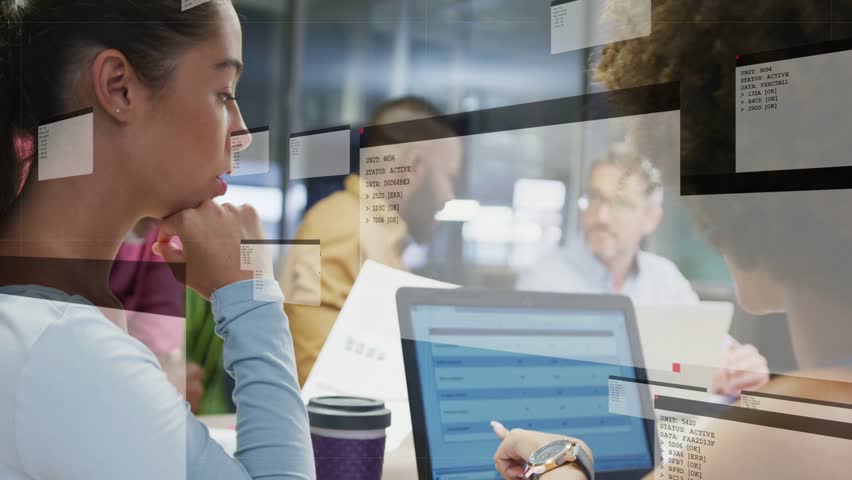 Meeting team in casual attire at laptop, cyan dot appearing, HUD expanding visualizing data. Collaboration, boardroom, office, teamwork, glitch, overlay, interface