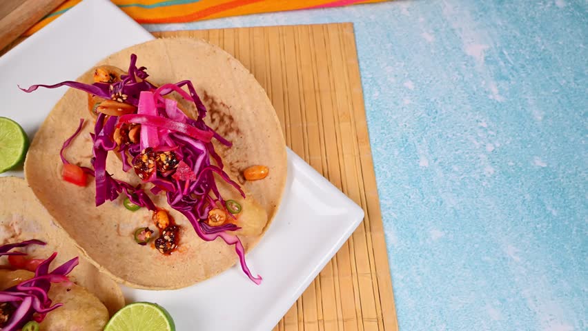 Aerial view of gourmet Mexican seafood tacos with fresh toppings and corn tortillas