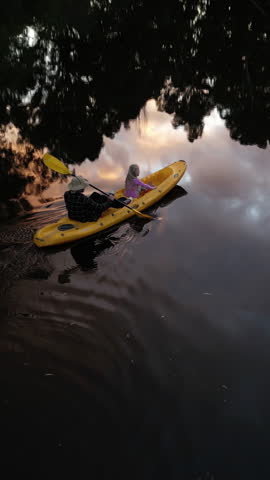 Drone, father and child on river with kayak ride, adventure and bonding together for holiday activity. Aerial, man and daughter canoeing in lake with outdoor sightseeing, travel and tourist vacation.