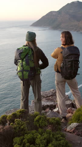 Back, hiking and women with celebration, ocean or cheering for training, challenge or wellness. Wow, hikers and people in nature, seaside or explore wilderness with gratitude, trekking or achievement