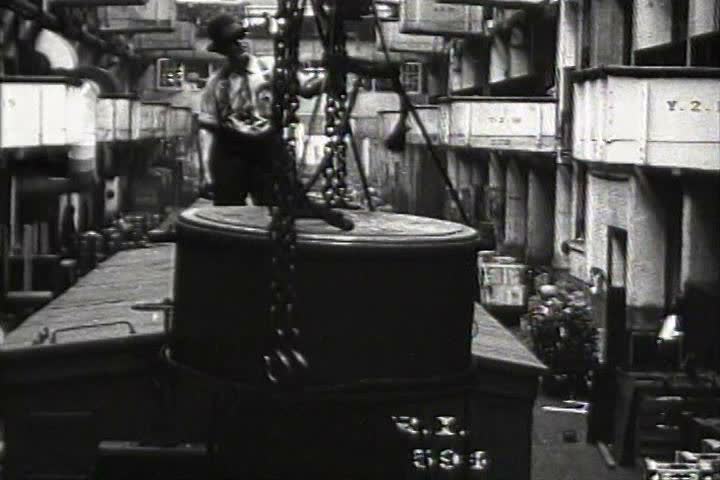 1920s - Freight cars are unloaded in a factory warehouse in 1920.