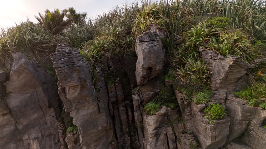 Close up drone shot, on the layered limestone formations of the Punakaiki Pancake Rocks of New Zealand
