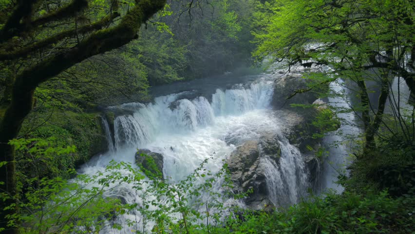 Turquoise waterfall cascading over rocky ledges. Martvili Canyon, Georgia