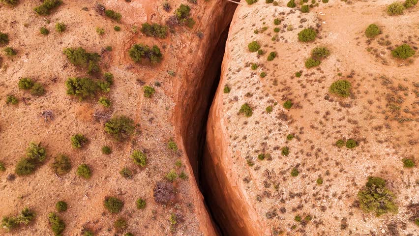 Dramatic aerial perspective of rugged rock formations in a desert canyon.