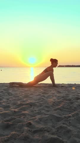 Stretching outdoors. yoga silhouette. yoga beach. Athletic young woman is practicing yoga at the beach during sunset or sunrise. Fitness training outdoors. doing sports in the morning.