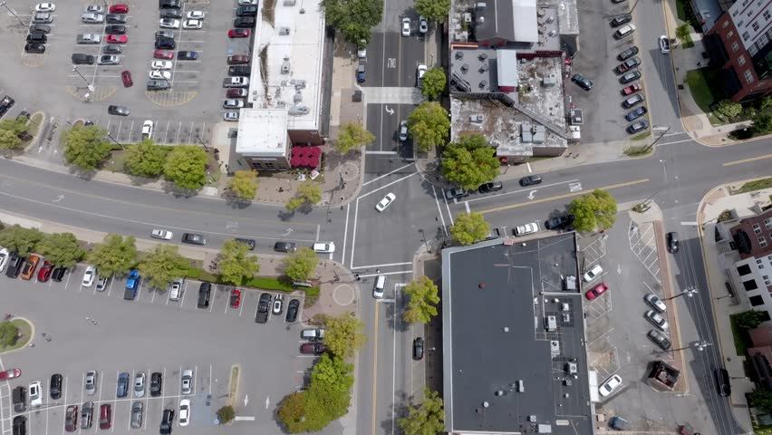 Downtown intersection in Tuscaloosa, Alabama with drone video moving down.
