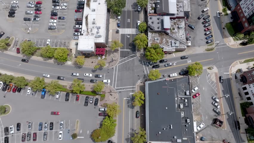 Intersection with traffic in downtown Tuscaloosa, Alabama with stable drone video.