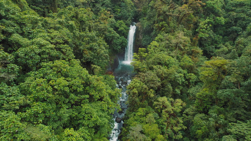 Scenic La Paz waterfall cutting through dense rainforest valley in Costa Rica