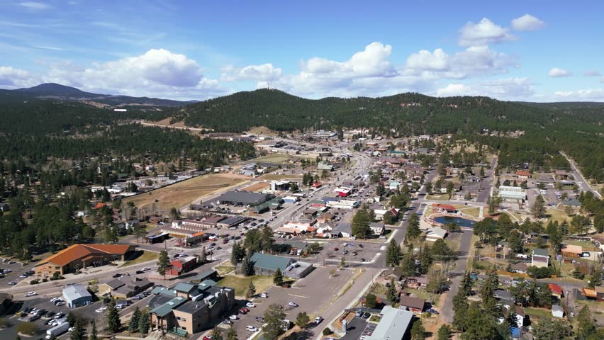 Beautiful view of woodland park Colorado with buildings and lush forest 