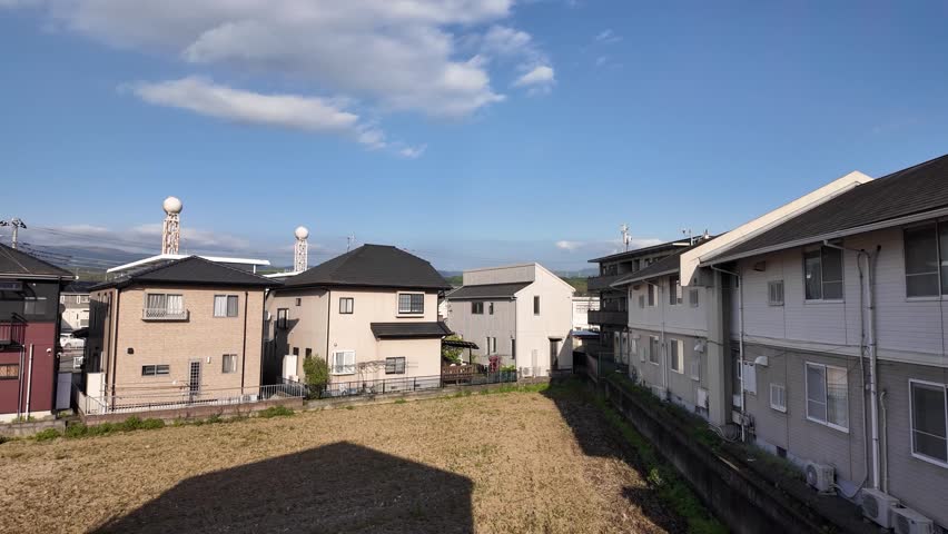 Timelapse of clouds covering blue sky over residential area, weather changing to overcast
