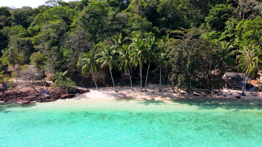 Explore the serene beauty of Koh Wai Island in Thailand, where white sandy beaches meet vibrant turquoise waters. Palm trees sway gently in the breeze, creating a perfect backdrop for relaxation.