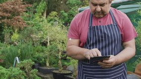 Gardener tapping tablet and expanding animated nodes and lines overlay, mapping nursery data. Garden, foliage, outdoor, horticulture, analytics, network, visualization - Powered by Shutterstock - Get 15% off with code: PIKWIZARD15
