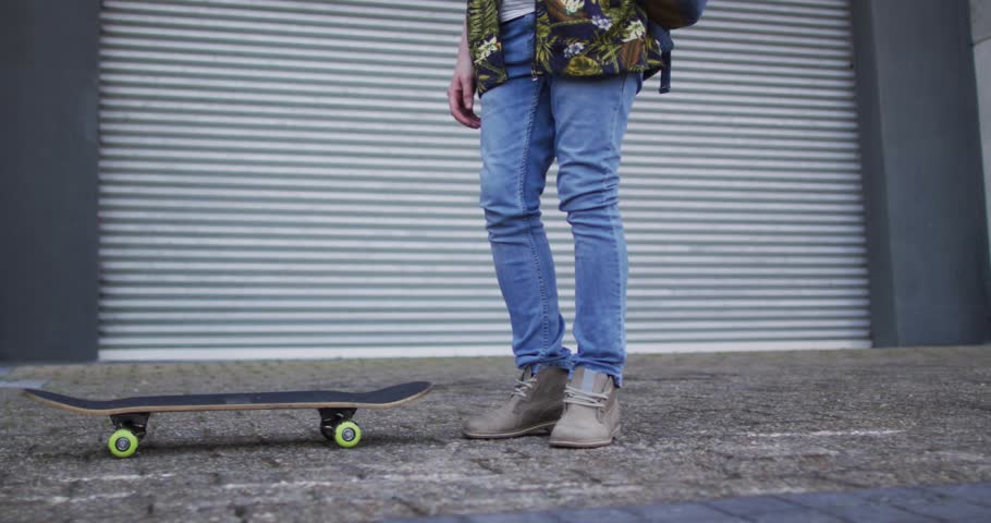 Adult skateboarder doing trick, activating world map overlay across skateboard for marketing demo. Urban, outdoor, industrial, dynamic, graphic, balance, motion
