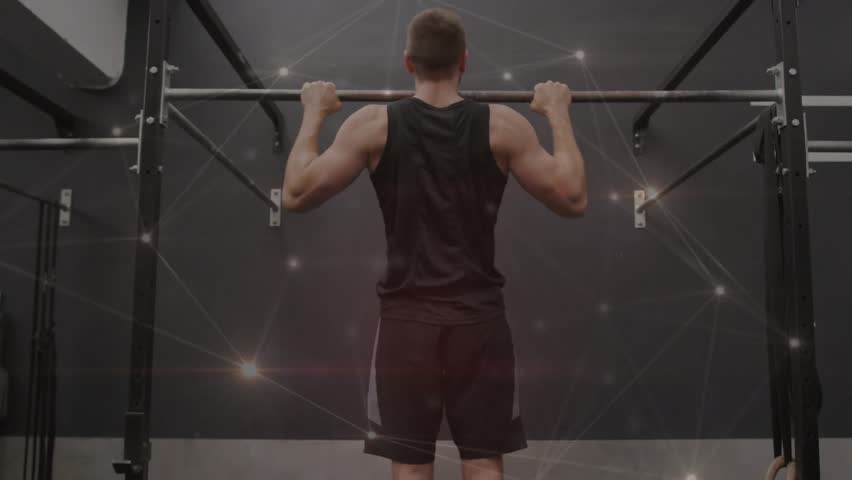 Man gripping pull-up bar and performing pull-ups in gym, particle network highlighting muscle gain. Athlete, training, strength, endurance, studio, neon, glow