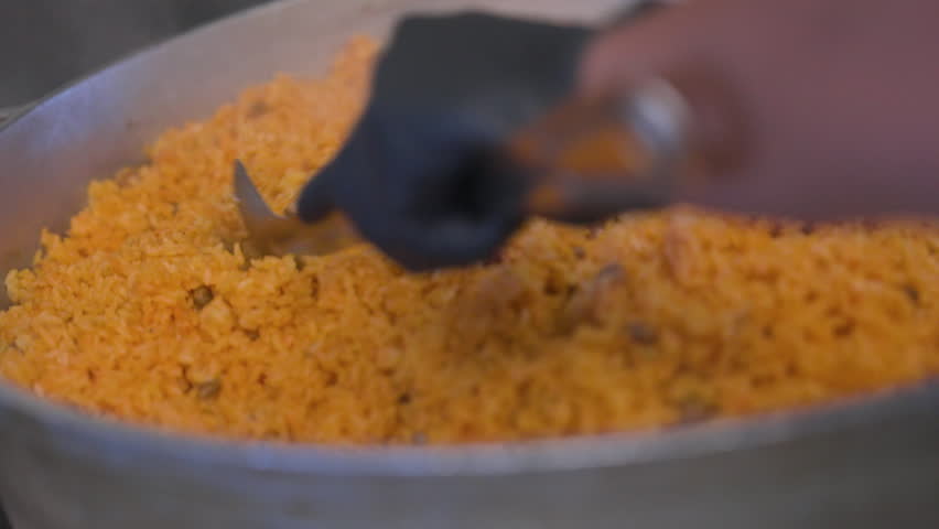 Large amount of Fried Rice being stirred around in a pot