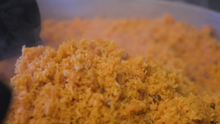 Large amount of Fried Rice being stirred around in a pot
