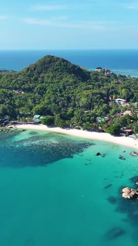 Stunning aerial view of a tropical beach in Thailand on a sunny day. Vertical video
