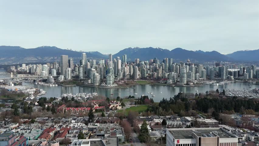 View Across False Creek Of David Lam Park Surrounded By Downtown Vancouver Skyline In Canada. wide aerial shot