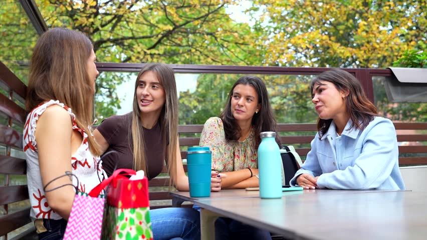Four young female friends chatting and enjoying each other