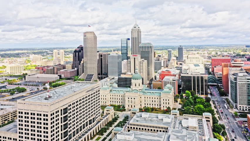 Aerial view of Indianapolis, Indiana with forward rotation towards the skyline and the State Capitol.