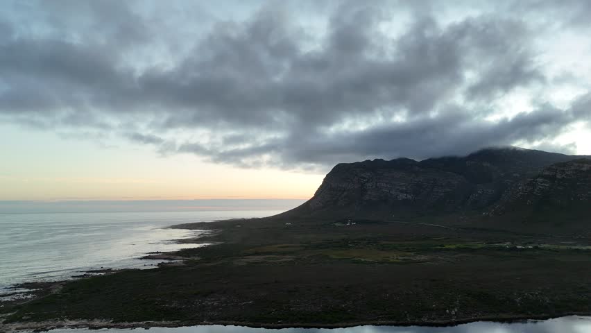 Dawn Over Wild Rocky Shoreline And Sea. Sunrise Illuminating South African Cliffs And Turbulent Waters