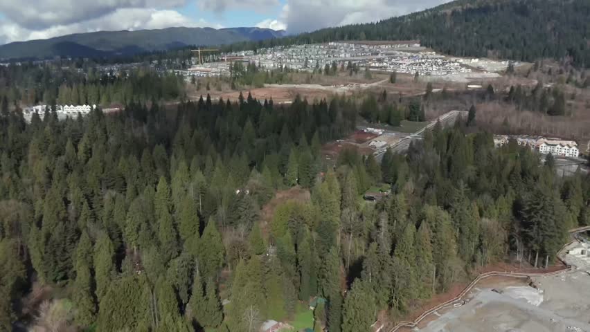 The Forested Area Along the Pitt River Contrasts With the Ongoing Development in Greater Vancouver, British Columbia, Canada - Drone Flying Forward