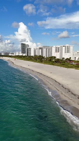 Aerial view of Miami Beach coastline with turquoise Atlantic water, sandy shore and urban waterfront, Florida USA. g.